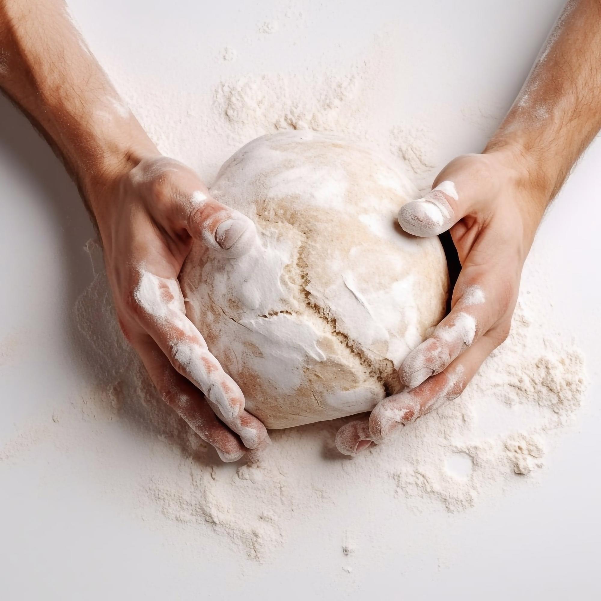 Close-up: hands kneading dough